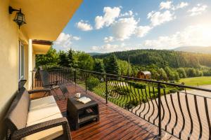 a balcony with a view of the mountains at Apartamenty Pod Horodkiem in Cisna