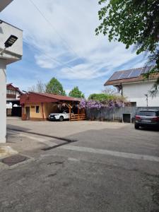 a building with a car parked in a parking lot at Riviera Valceana in Râmnicu Vâlcea