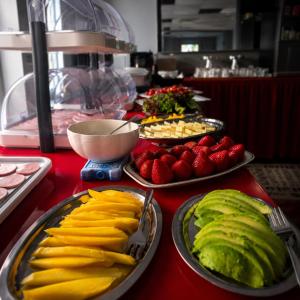 a table topped with plates of fruits and vegetables at Hotel Elisenhof in Chemnitz