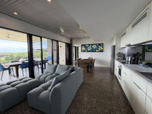 a kitchen and living room with a couch and a table at Cooktown Getaway in Cooktown