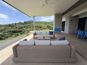 a living room with two couches and a table at Cooktown Getaway in Cooktown