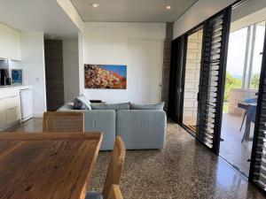 a living room with a couch and a table at Cooktown Getaway in Cooktown