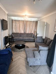 a living room with a couch and a table at The Stanford Home in Horndon on the Hill