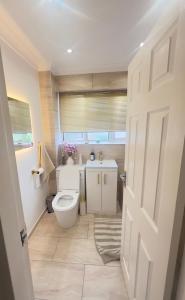 a bathroom with a toilet and a sink at The Stanford Home in Horndon on the Hill