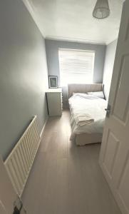 a small bedroom with a bed and a window at The Stanford Home in Horndon on the Hill