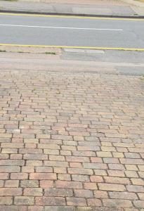 a brick sidewalk on the side of a street at The Stanford Home in Horndon on the Hill
