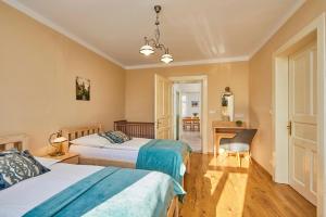 a bedroom with two beds and a desk and a chair at Villa Harmony in Český Krumlov