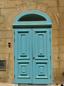 a blue door with a window on a building at Republic Stay in Valletta