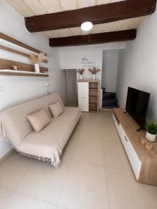 a living room with a couch and a flat screen tv at Republic Stay in Valletta