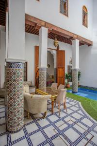 a living room with a table and chairs at Riad Old City Palace in Fez