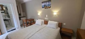 a small bedroom with a bed and a bathroom at Hotel Adonis in Mythimna