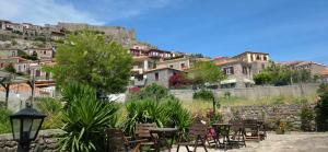 a group of tables and chairs in front of a mountain at Hotel Adonis in Mythimna