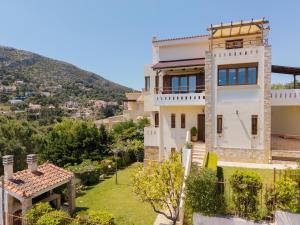 a villa with a view of the mountains at Theros Maisonette by A&D Properties in Porto Rafti