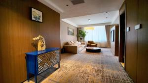 a living room with a couch and a table at Red Rock Resort Mongolia in Yoliin Hural