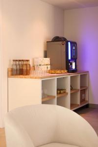 a room with a counter with a microwave on a table at Hôtel Casa Elena in Erbalunga +26 photos