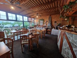 a restaurant with tables and chairs in a building at garni Hotel ASAS*** in Most