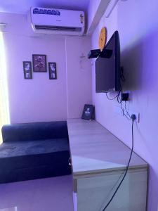 a room with a desk with a tv and a bed at Lord krisna place --Near Prem Mandir & ISKCON in Vrindāvan +10 photos