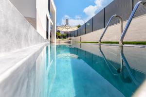 a swimming pool with blue water next to a building at Villa Sarah in Vantačići