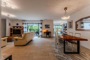 a living room with a table and a couch at Le Reve Mimizan Plage in Mimizan-Plage