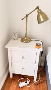 a white dresser with a lamp on it next to a bed at Avenidas Prime Lisbon in Lisbon +36 photos
