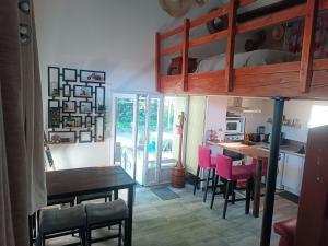 a kitchen with a table and chairs and a bunk bed at Chez Delph in Rognonas