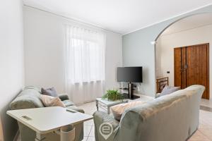 a living room with two couches and a table at Estay - Casa Bo' in city center - AirCon - WiFi in Tortolì