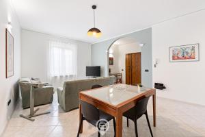 a living room with a table and a couch at Estay - Casa Bo' in city center - AirCon - WiFi in Tortolì +26 photos