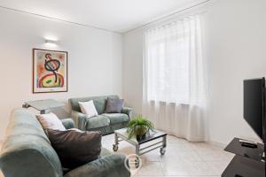 a living room with a couch and a tv at Estay - Casa Bo' in city center - AirCon - WiFi in Tortolì