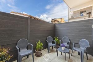 a patio with chairs and tables and a fence at Estay - Casa Bo' in city center - AirCon - WiFi in Tortolì