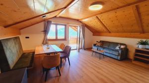 a living room with a couch and a table at Residence Krone in Schenna