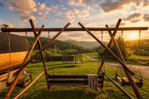 a swing in a yard with a view of a mountain at Apartamenty Pod Horodkiem in Cisna