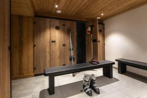 a bench in a room with wooden walls at Résidence Almes 1 et Almes 2 by Alpapart in Tignes