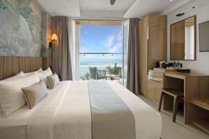 a bedroom with a large bed with a view of the ocean at Hotel Amber Seaside in Hulhumale +52 photos