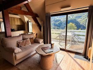 a living room with a couch and a table at ISKÖ CHALETS-HÖTEL, Col d'Aubisque in Gourette