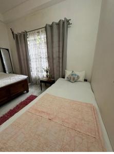 a bedroom with a large bed and a window at SS Hostel Siliguri in Siliguri