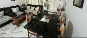 a living room with a black table and chairs at SS Hostel Siliguri in Siliguri