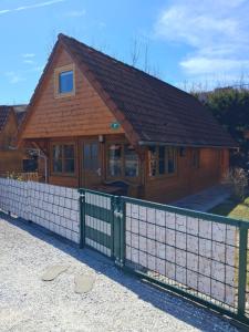 a wooden house with a fence in front of it at Haus Marlies in Spielberg