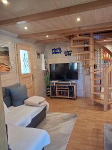 a living room with a couch and a flat screen tv at Haus Marlies in Spielberg