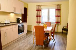 a kitchen and dining room with a table and chairs at Seetuun-Hoff - Dree in Nordstrand