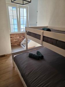 two bunk beds in a room with a window at Appartement cosy 2 chambres in Wenduine
