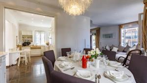 a dining room with a table and a living room at VILLA CORONA 8, Emma Villas in Cattolica