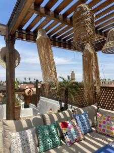 a couch sitting under a pergola on a patio at Riad Le Grizzly in Marrakesh