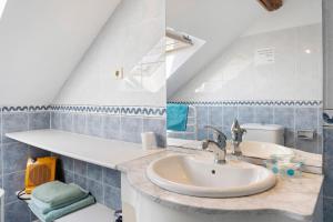 a bathroom with a sink and a toilet at Chambres D'hotes Vignolo in Pontiacq-Viellepinte +47 photos