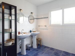 a bathroom with two sinks and two mirrors at War Ar Maez in Pleumeur-Bodou +22 photos