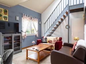 a living room with a couch and a table at War Ar Maez in Pleumeur-Bodou