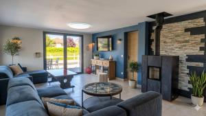 a living room with a couch and a fireplace at Maison avec toit terrasse in Villers-sur-Mer