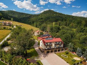 an aerial view of a house in the mountains at Apartamenty Pod Horodkiem in Cisna