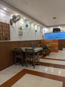 a dining room with tables and chairs in a restaurant at LlBRA REGENCY in Guruvāyūr