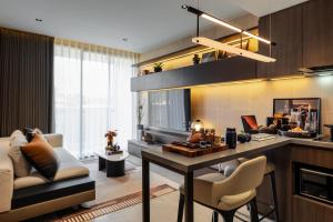 a kitchen and living room with a table and chairs at The Panora Estuaria Pattaya in Na Jomtien