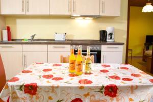a table with a flowered table cloth with bottles on it at Seetuun-Hoff - Dree in Nordstrand +11 photos